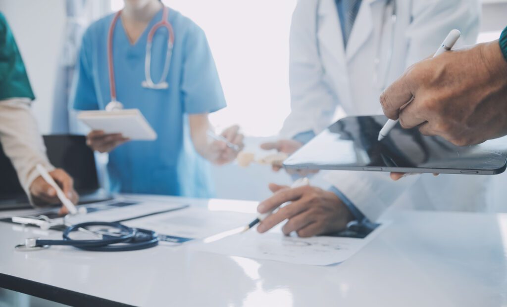 Photo of clinicians and electronic health records